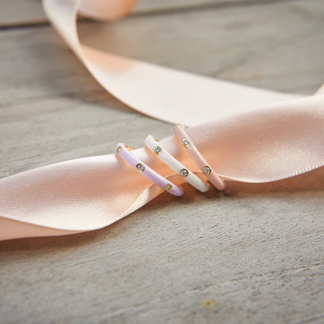 EF-Collection 3 Diamond & White Enamel Stack Ring in yellow gold styled on a light pink ribbon