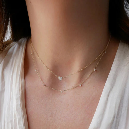 EF-Collection 7 Prong Set Diamond Necklace in yellow gold on models neck with heart diamond necklace