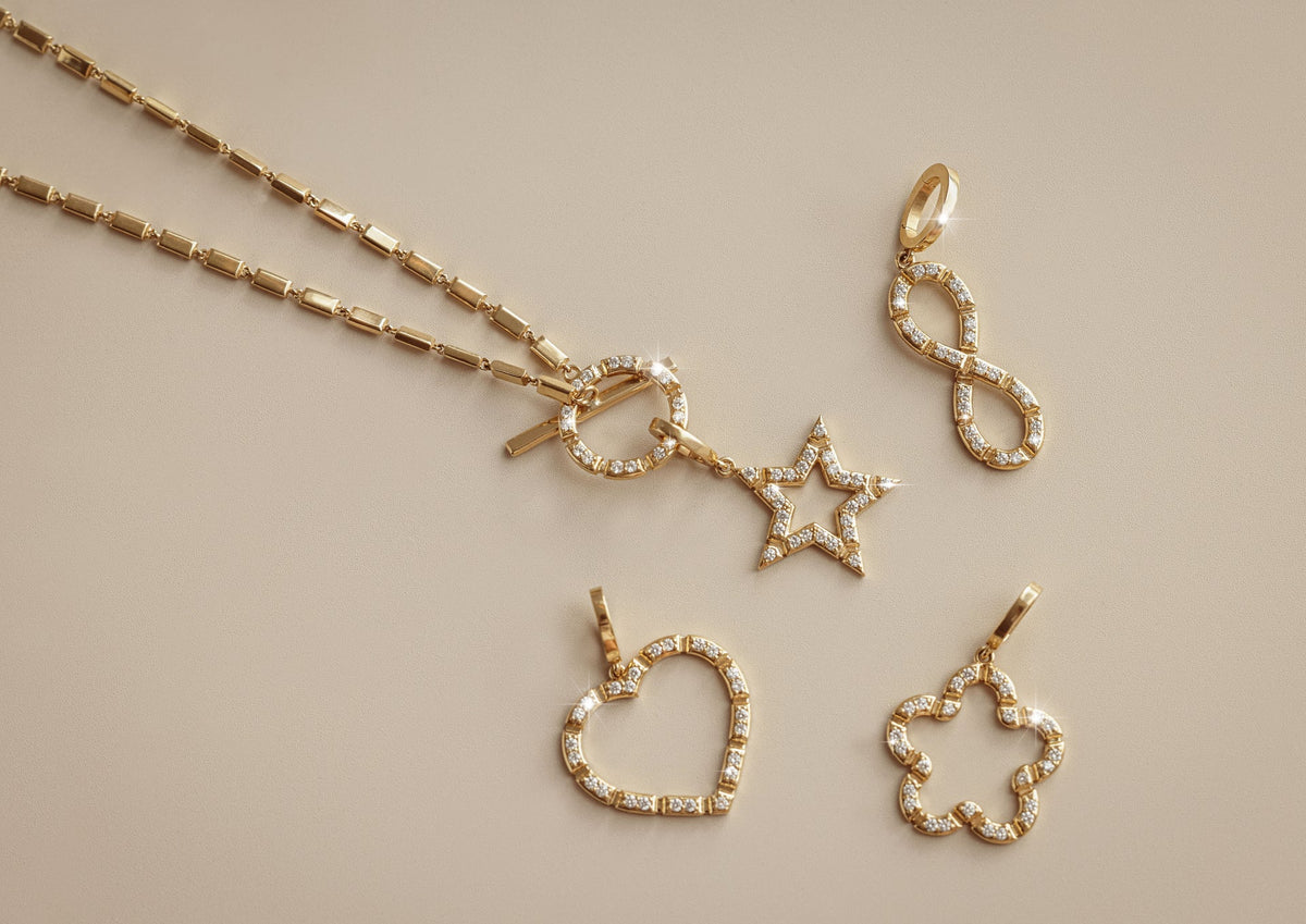 Onirikka Charms in 18k yellow gold with diamonds, featuring an enhancer clip to attach to most necklaces.