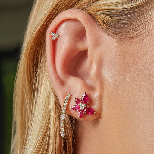 Close Up of Ef-Collection Emerald and Diamond Trio Cluster stud Earrings in yellow gold over a white background.