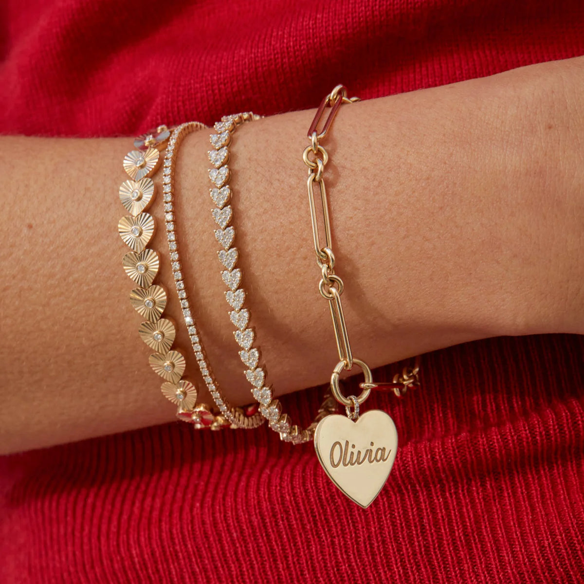 EF Collection Gold Jumbo Heart Charm Bracelet in yellow gold styled on models wrist.