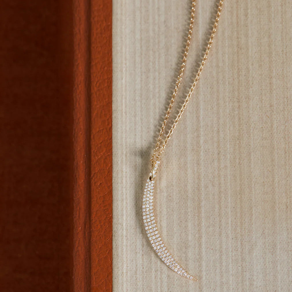 image of EF-Collection Diamond Crescent Necklace in yellow gold and diamond on a textured background.