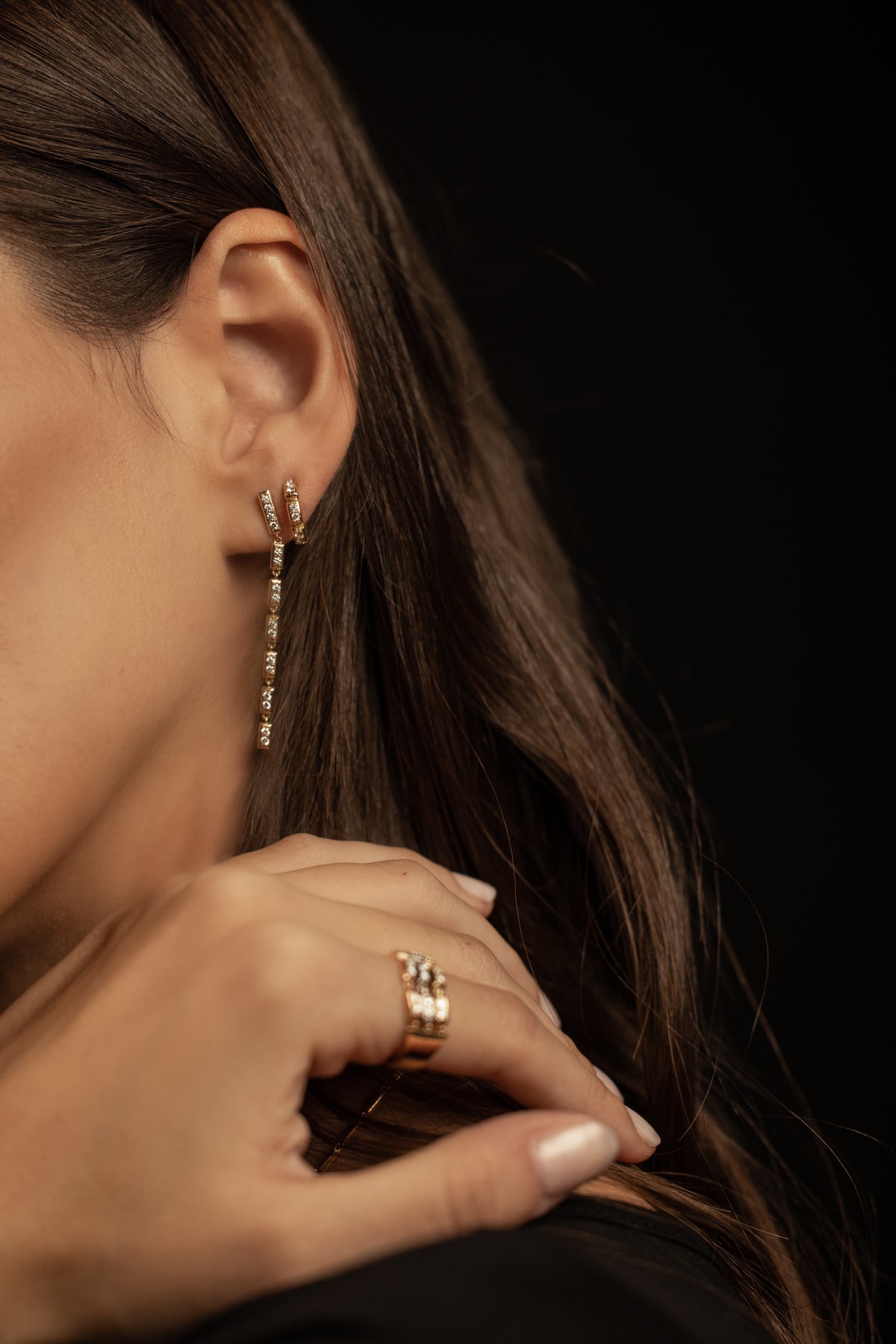 close up of model wearing Onirikka Stilleto drop earrings in yellow gold and diamonds.