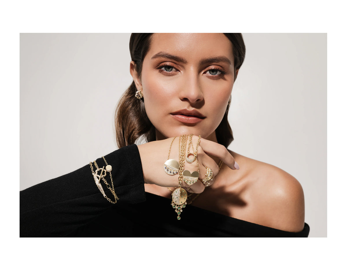model wearing Onirikka Petite La Luz Bracelet in 18k yellow gold.