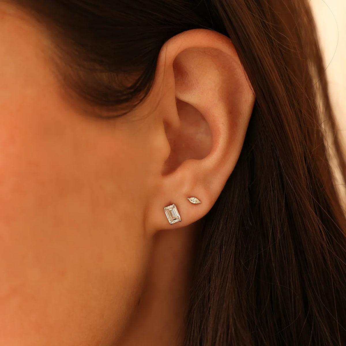 Dana Rebecca Designs Alexa Jordyn Marquise Diamond Single Stud Earring in yellow gold on models ear layered with emerald cut diamond stud