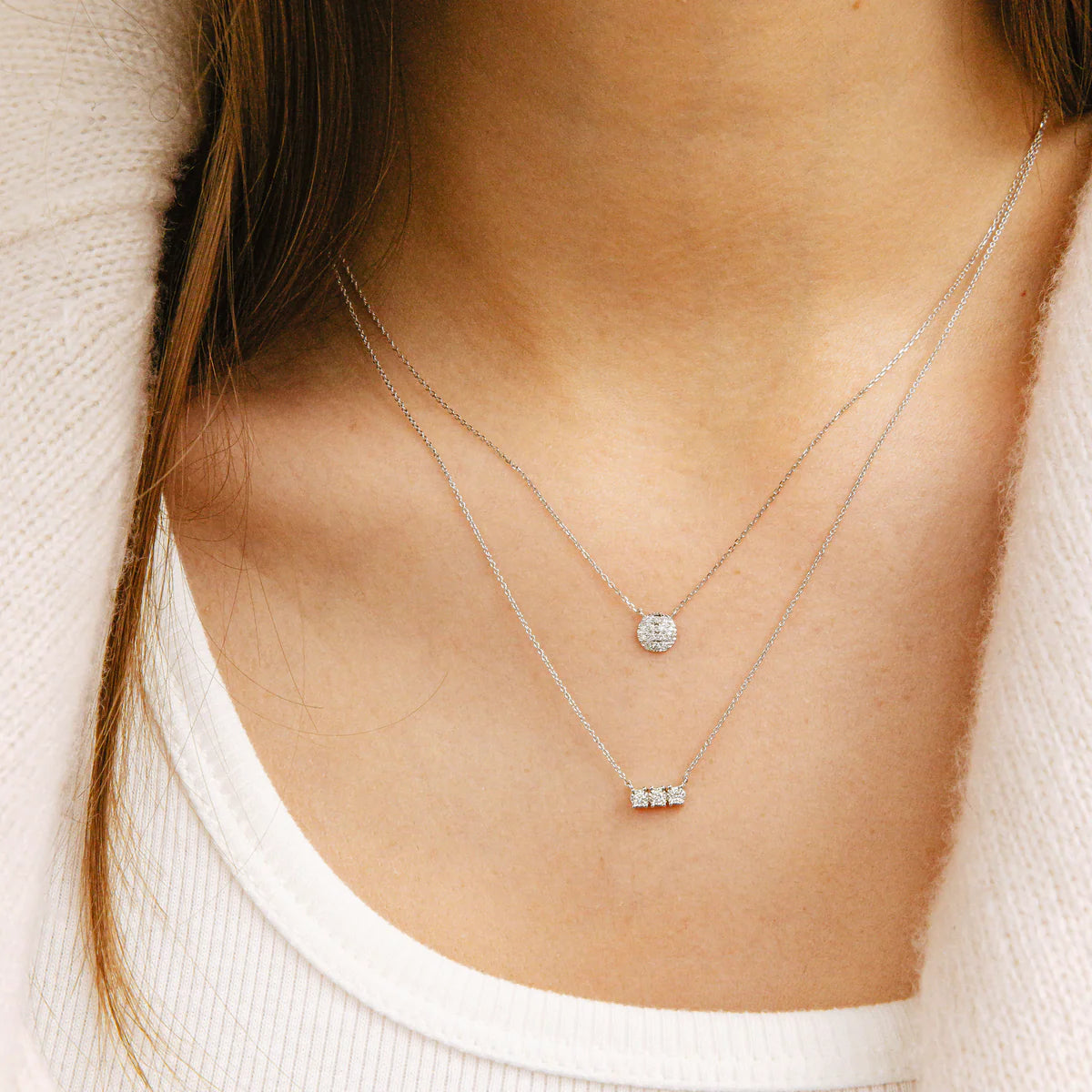 close up of Dana Rebecca Designs Ava Bea Bar Necklace in white Gold layered with other necklaces.