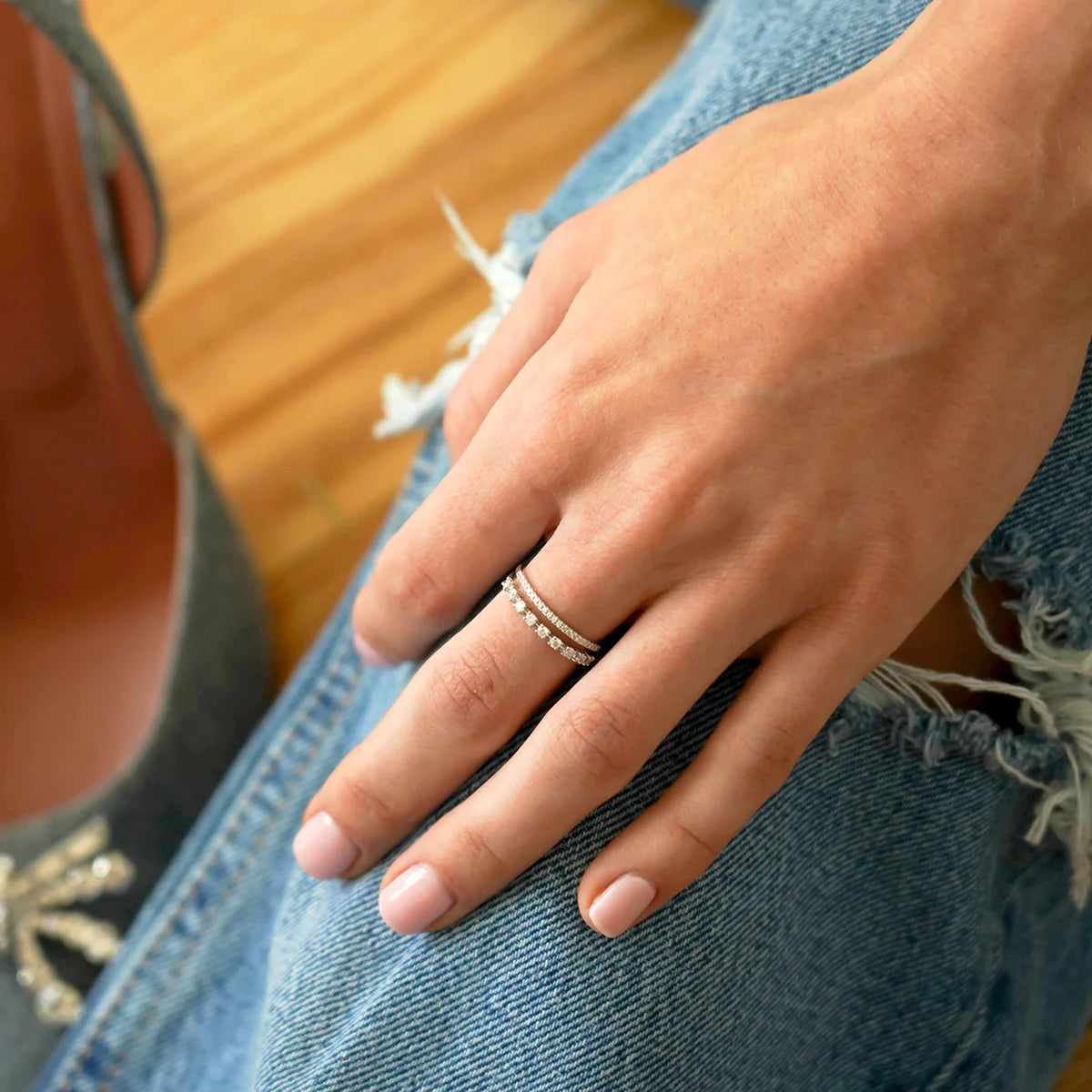 Dana Rebecca Designs Ava Bea Double Row Ring in white gold styled on models hand with jean background