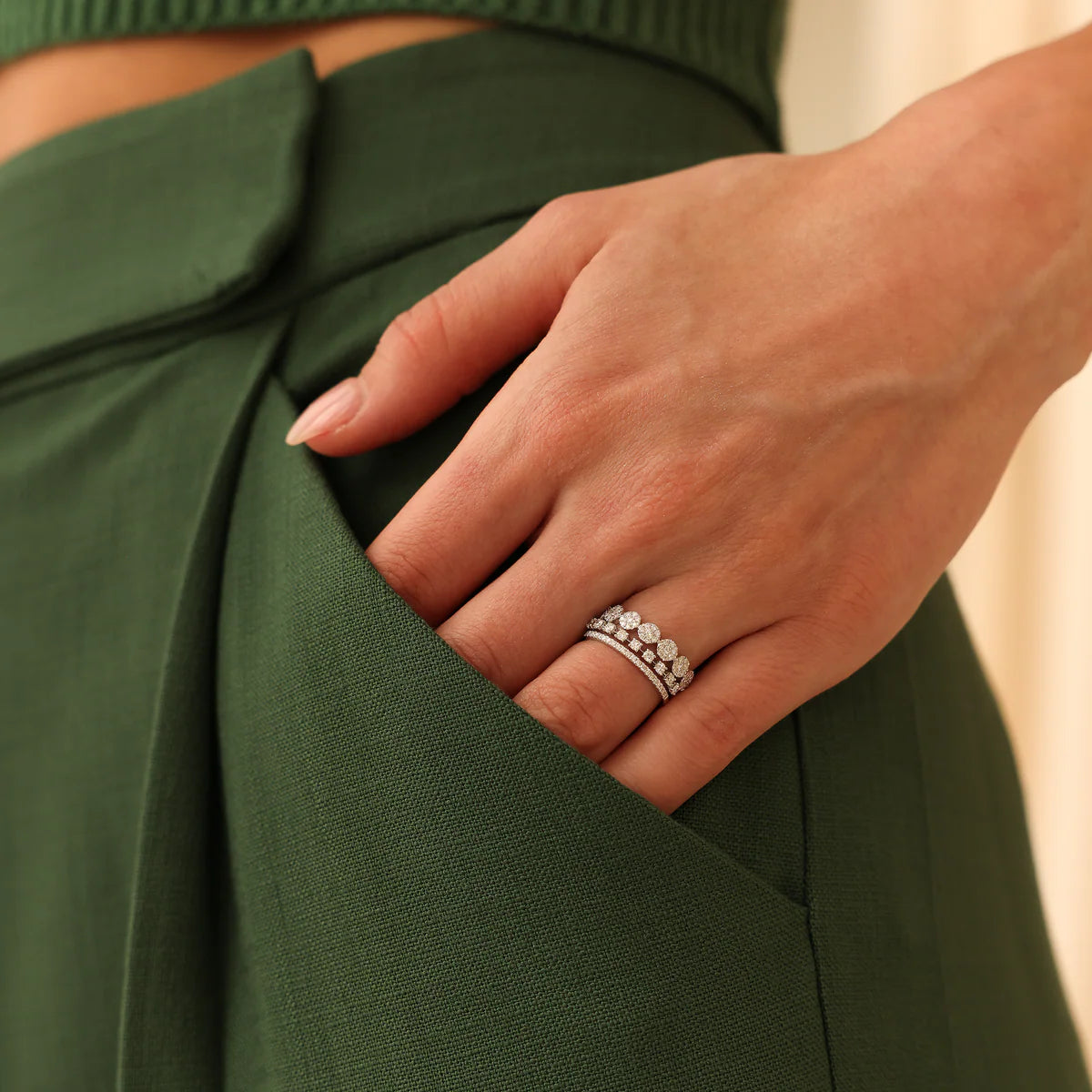 Dana Rebecca Design ava Bea Double Row Ring in white gold styled on models hand with green background.