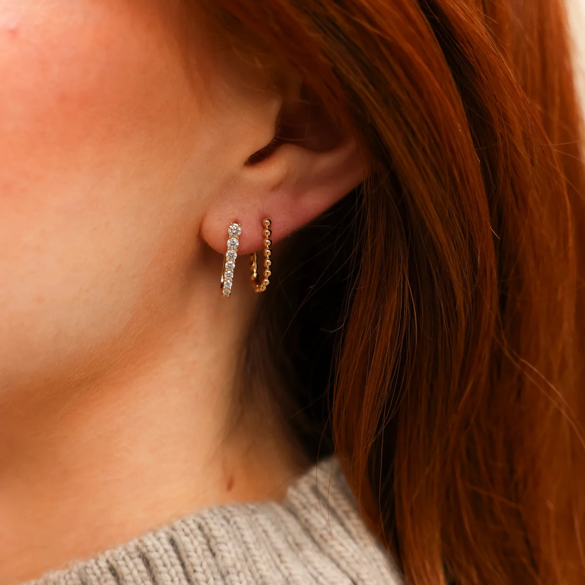 Dana Rebecca Designs Ava Bea Graduating U Hoops in yellow gold on models ear with red hair