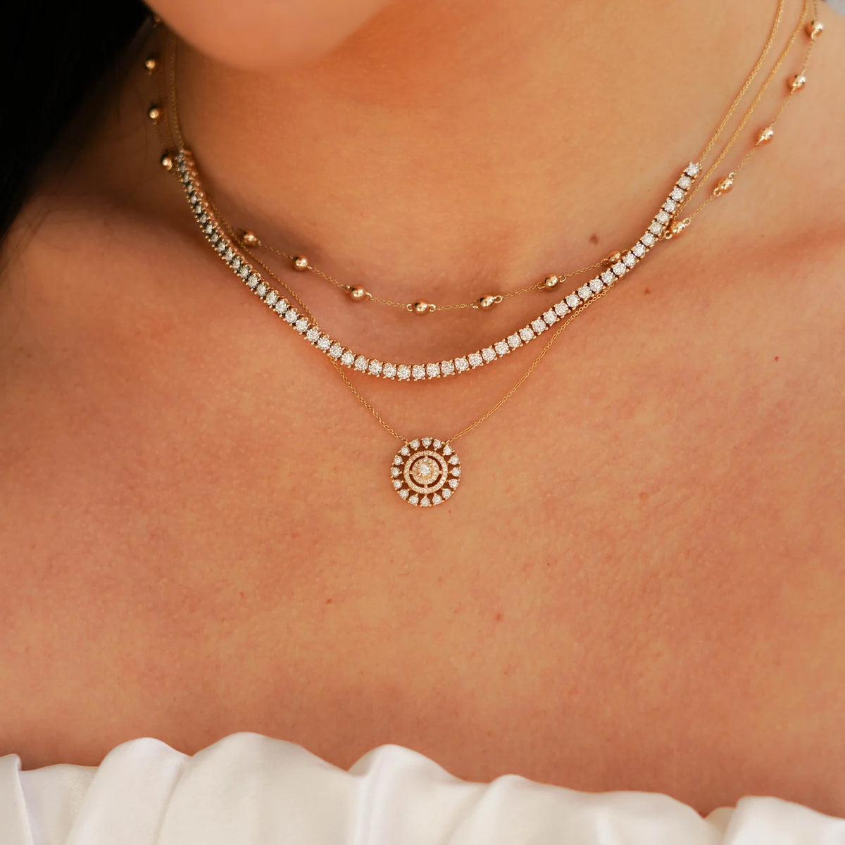 Dana Rebecca Designs Ava Bea Medallion Necklace in yellow gold styled on models neck with ava bea tennis necklace