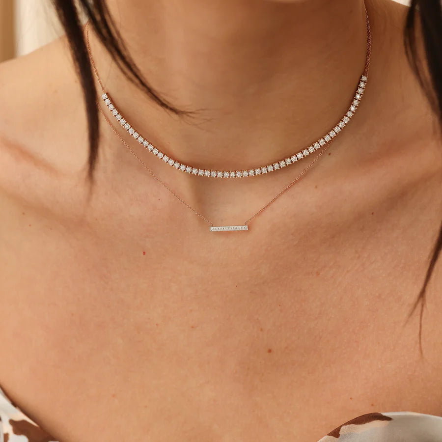 Dana Rebecca Designs Ava Bea Tennis Necklace in yellow gold on models neck styled with diamond bar necklace