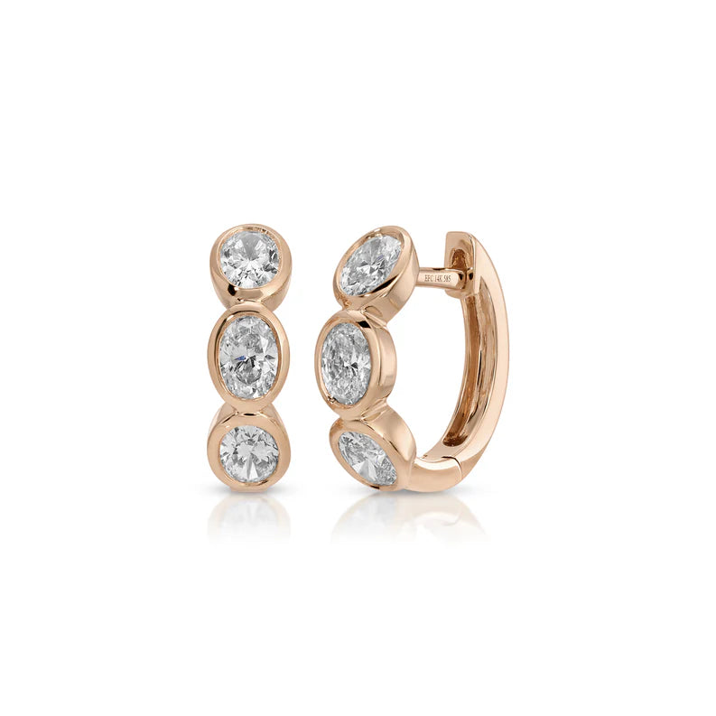 EF Collection Bezel Set Oval Diamond Huggie Earrings in rose gold on white background