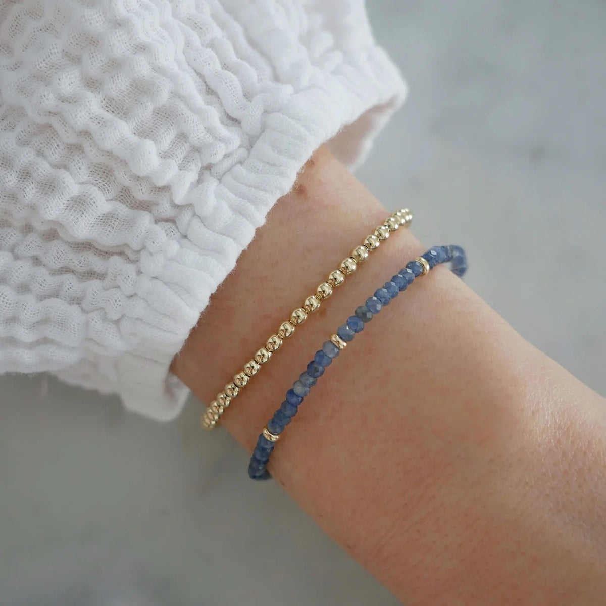 EF-Collection Birthstone Bead Bracelet In Blue Sapphire in yellow gold on models wrist with gold beaded bracelet