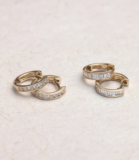 EF-Collection Channel Set Diamond Huggie Earrings in yellow gold on a neutral background