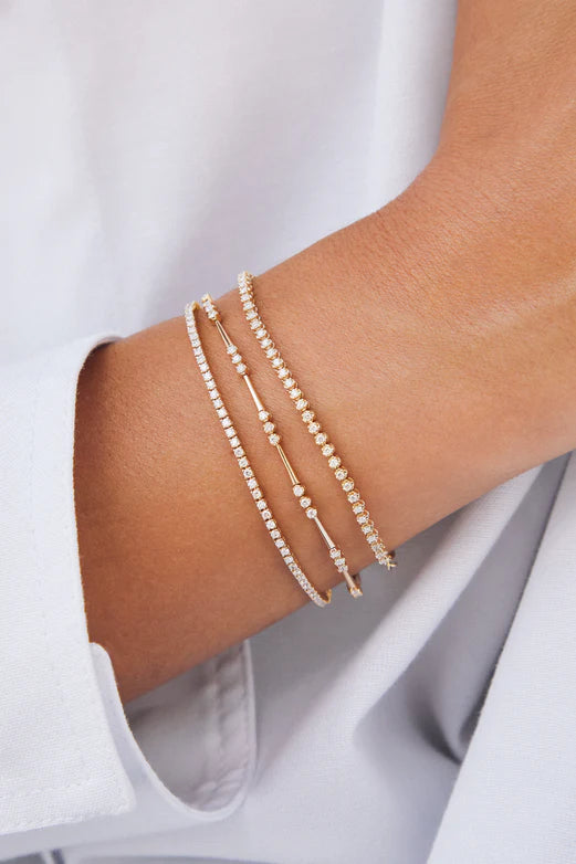 EF Collection Crown Set Diamond Eternity Bracelet in yellow gold styled on model's wrist.