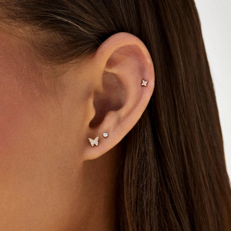 EF Collection Diamond Baby Butterfly Stud Earring in yellow gold styled on models ears with diamond studs.