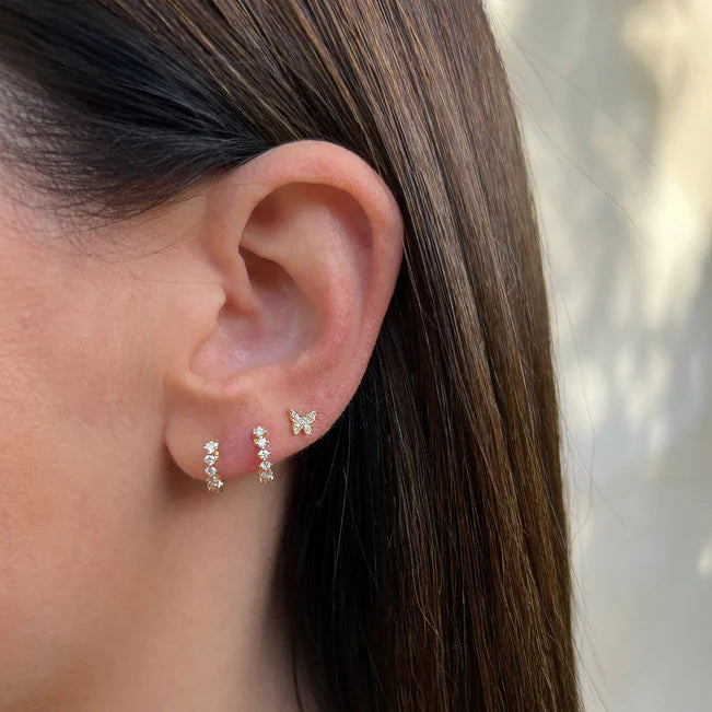 EF Collection Diamond Baby Butterfly Stud Earring in yellow gold styled on models ear with diamond huggies.
