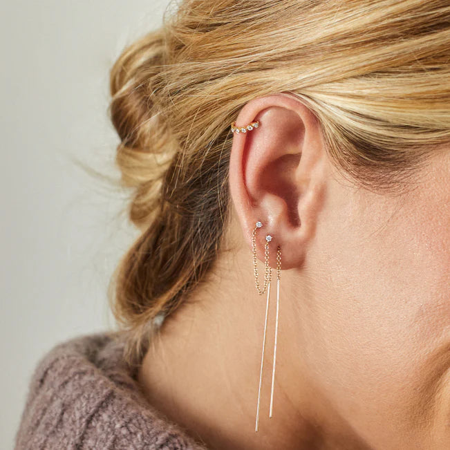 EF Collection Diamond Bezel Mini Huggie Earring in yellow gold styled on models ear.