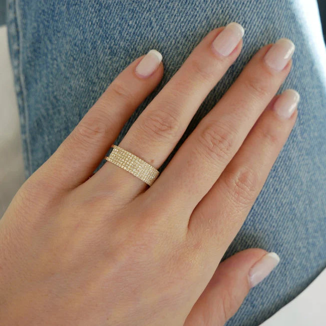 Single EF Collection Diamond Cigar Band Ring in yellow gold on model’s hand.