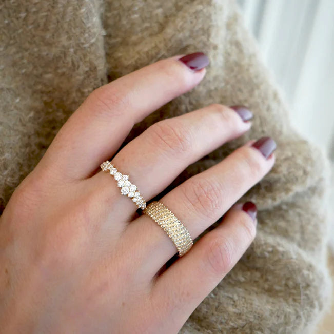 EF Collection Diamond Cluster Ring in yellow gold paired with gold ring on model’s finger.
