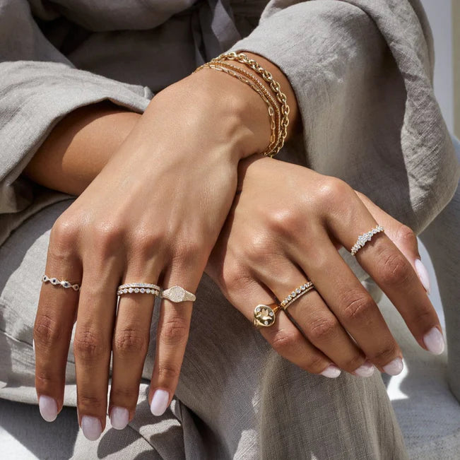 EF Collection Diamond Hummingbird Signet Ring in yellow gold on model’s finger paired with diamond bands.