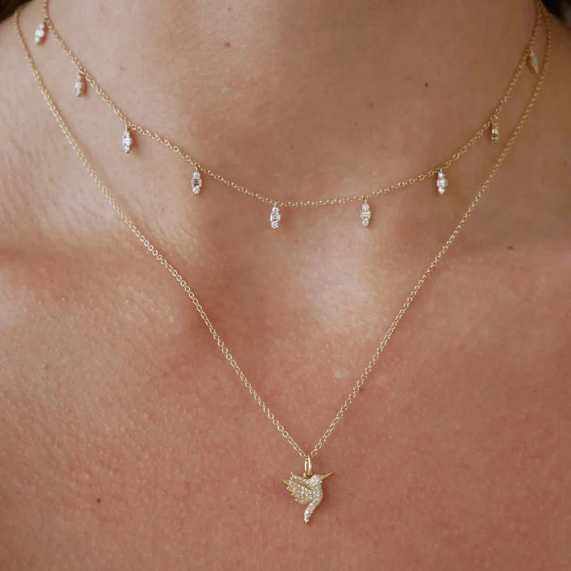 EF Collection Diamond Mia Necklace in yellow gold on models neck with diamond hummingbird necklace.
