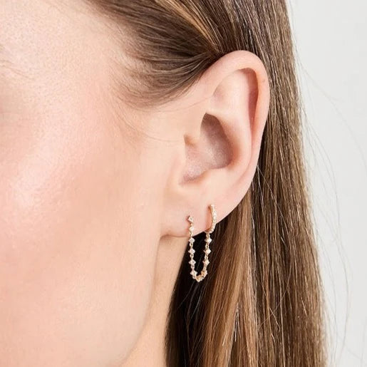 Single EF-Collection Diamond Mini Huggie & Prong Set Chain Stud Earrings in yellow gold on models ear