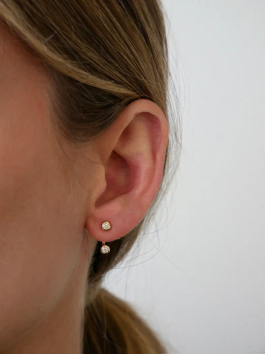 Ef collection Single Diamond Pillow Illusion Earrings in yellow gold on models ear.