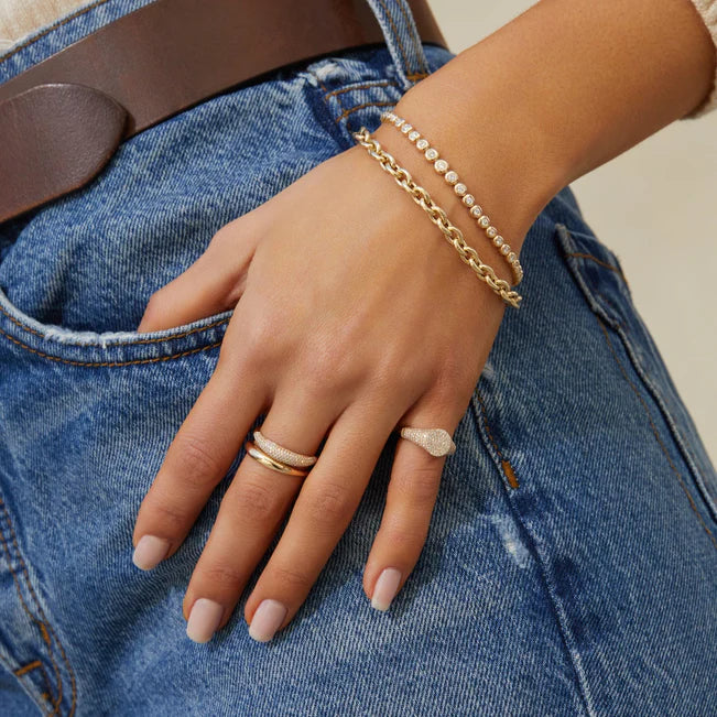 EF-Collection Diamond Signet Ring in yellow gold on white background styled on models finger wearing a jean