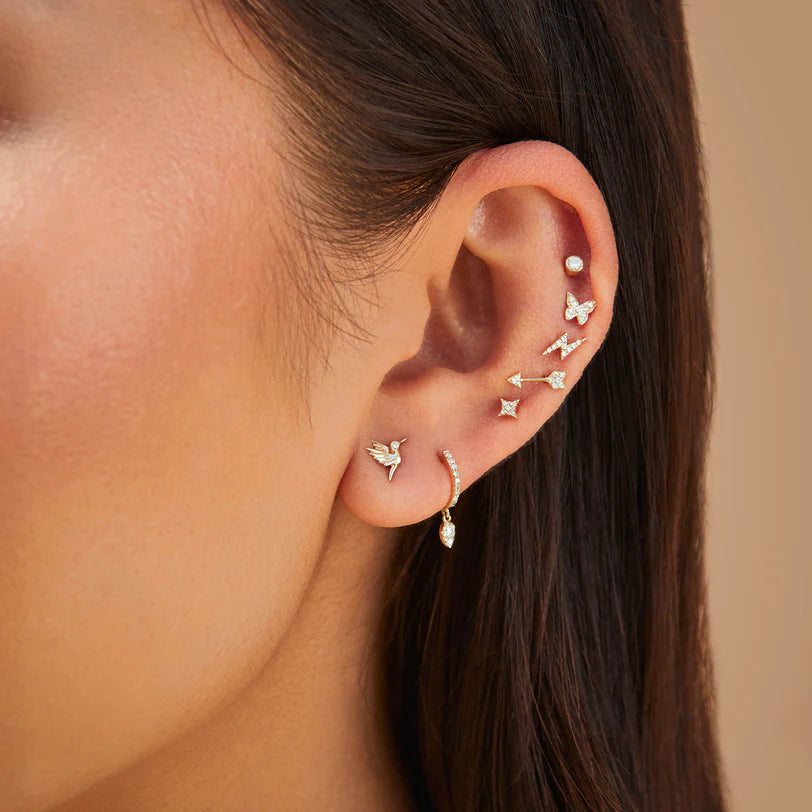 Close up of EF Collection Diamond Sparkle Stud Earring in yellow gold on models ears layered with studs.