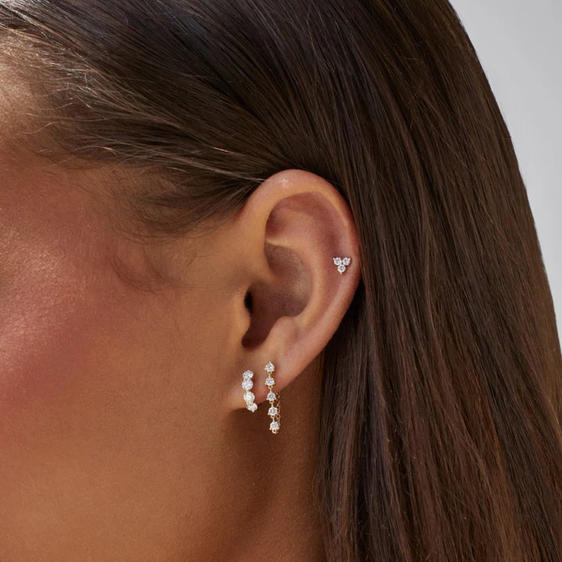 EF Collection Diamond Trio Stud Earring in yellow gold stacked on models ear with diamond huggies.