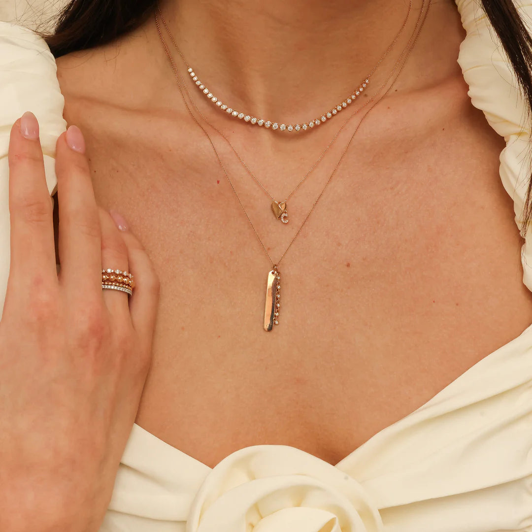 Dana Rebecca Designs DRD Diamond Initial Charm in yellow gold styled on models neck