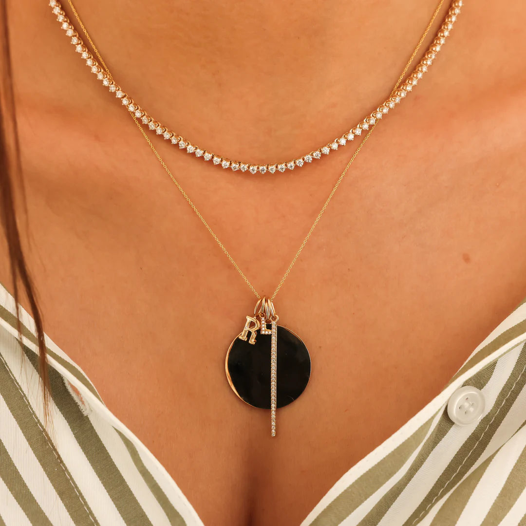 Dana Rebecca Designs DRD Gold Initial Charm in yellow gold on models neck with diamond tennis necklace