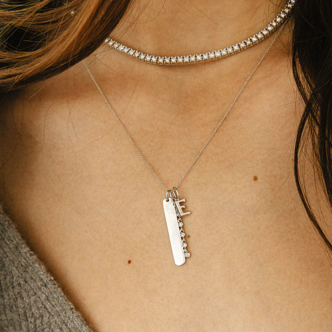 Dana Rebecca Designs DRD Gold Initial Charm in white gold styled on models neck with ava bea diamond tennis necklace