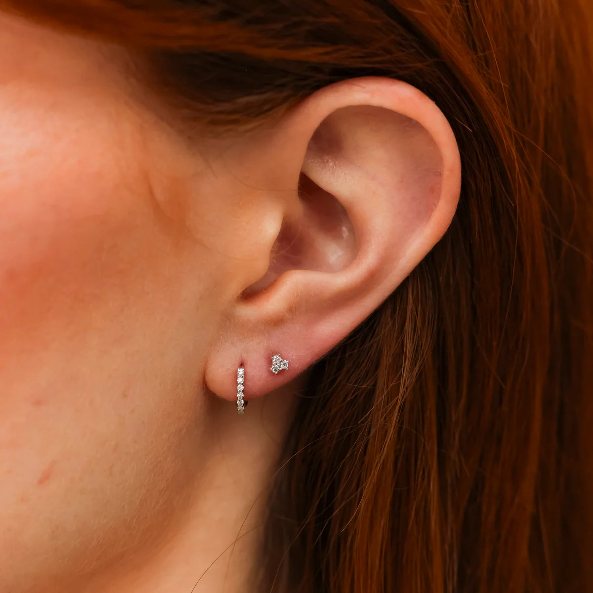 model shot of DRD Diamond Mini Huggies in 14K Yellow Gold on an ear