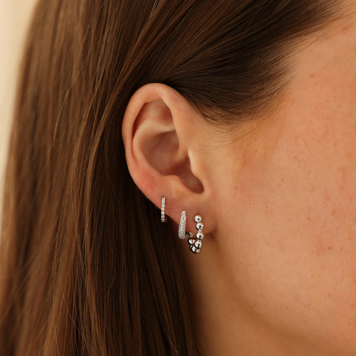 White Gold Diamond Huggie Earrings: DRD Tapered Huggies In White Gold