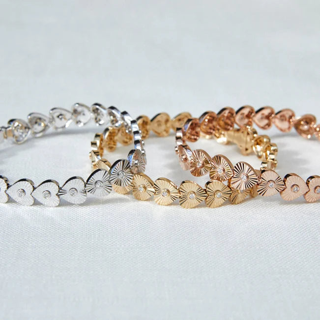 EF Collection Gold & Diamond Fluted Heart Eternity Bracelet in yellow, white, and rose gold on white background.