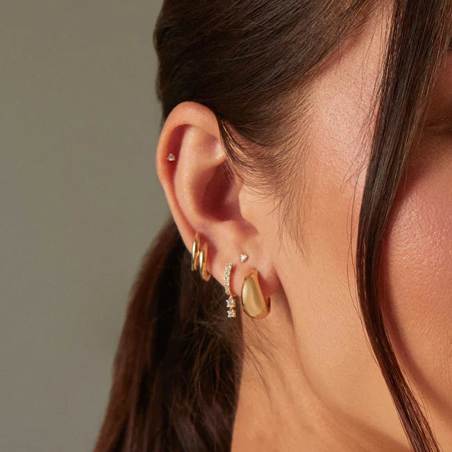 EF Collection Gold Dome Huggie Earring pair in yellow gold styled on models ear with diamond huggie
