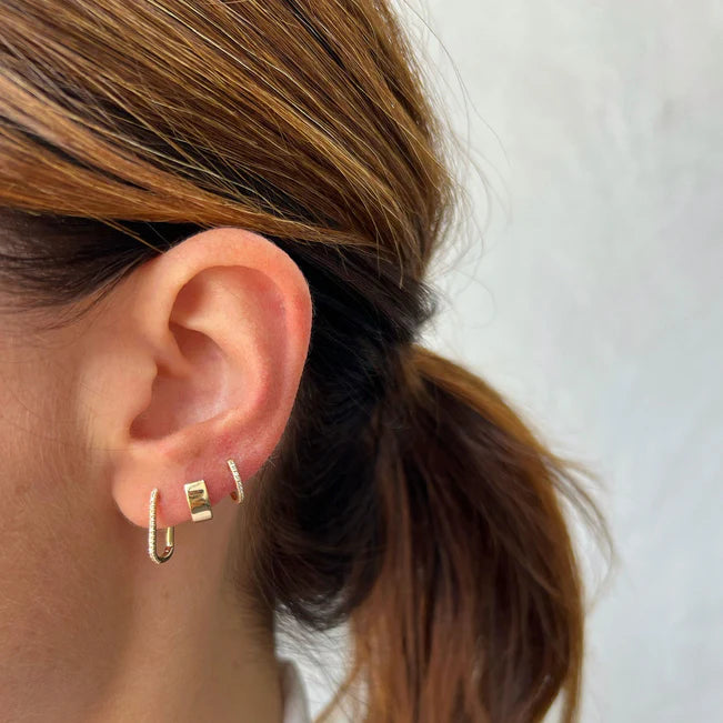 Ef collection Single Gold Jumbo Huggie Earrings in yellow gold stacked on models ear.