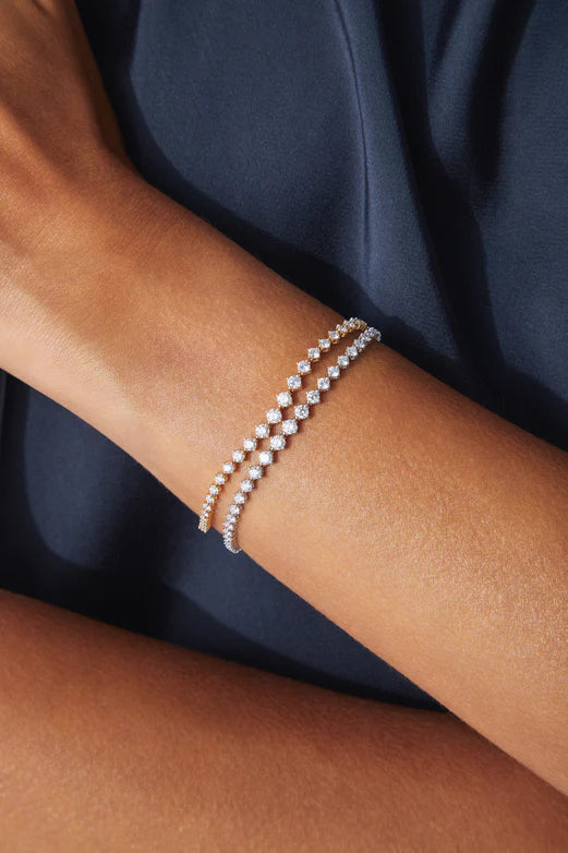 EF Collection Graduated Diamond Eternity Bracelet in yellow and white gold on model's wrist.