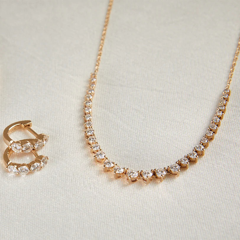 EF-Collection Graduated Diamond Necklace in yellow gold on white background with round diamond huggies
