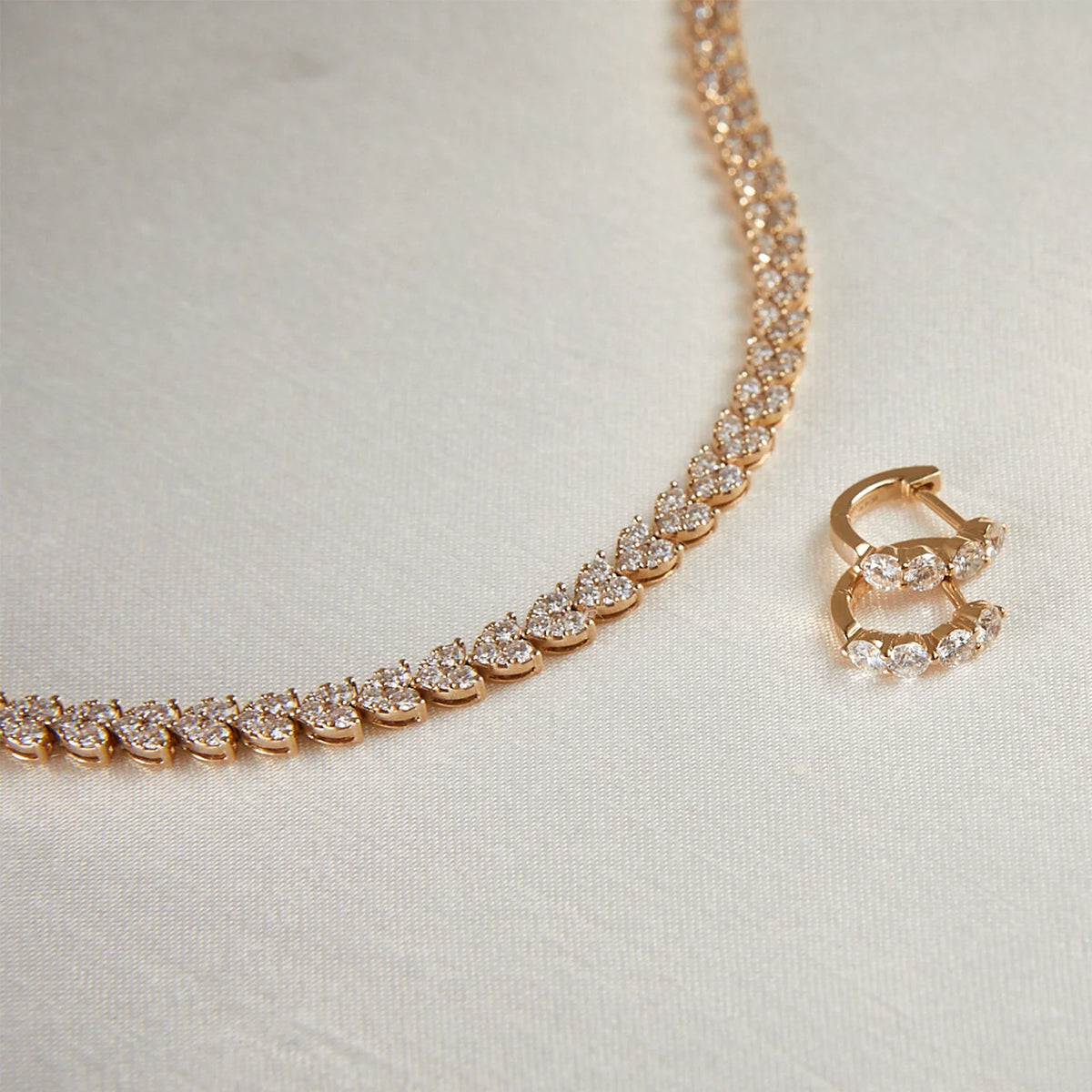 EF-Collection Jumbo Prong Set Diamond Mini Huggie Earrings in rose gold with diamond heart tennis necklace