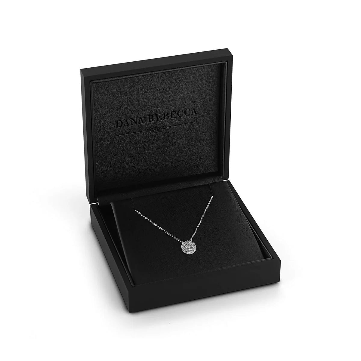 Close up of Dana Rebecca Designs Lauren Joy Medium Disc Necklace in white Gold on a black box