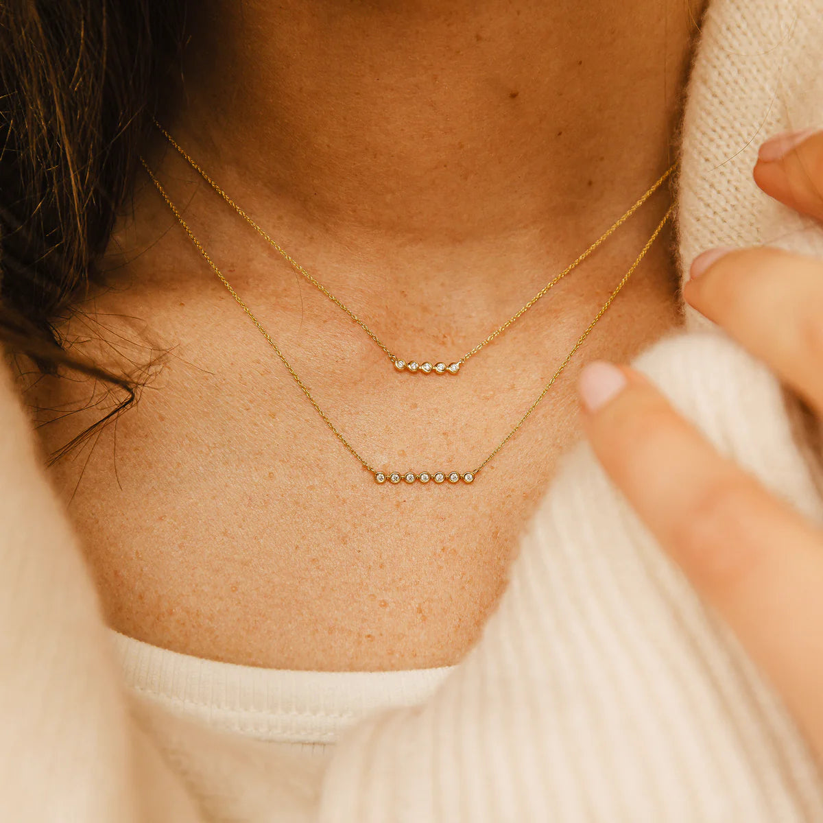 close up of Dana Rebecca Designs Lulu Jack Mini Bezel Bar Necklace in Yellow Gold layered with a bar necklace