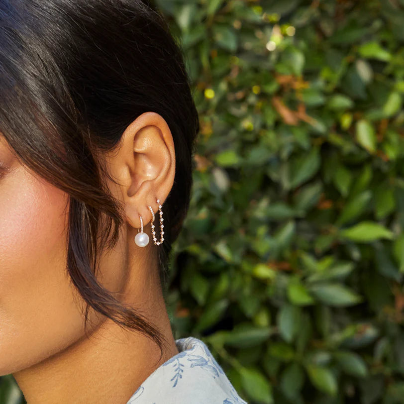 Ef collection Pearl Ball Drop Earrings styled on models ear layered with a chain and diamond earring.