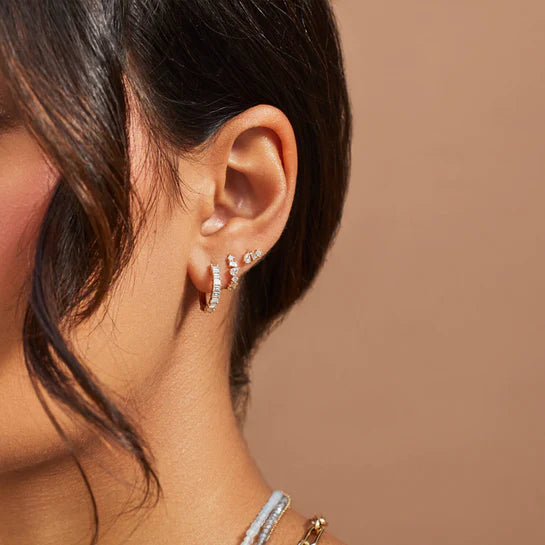 EF-Collection Prong Set Diamond Baguette Hoop Earrings in yellow gold styled on models ear