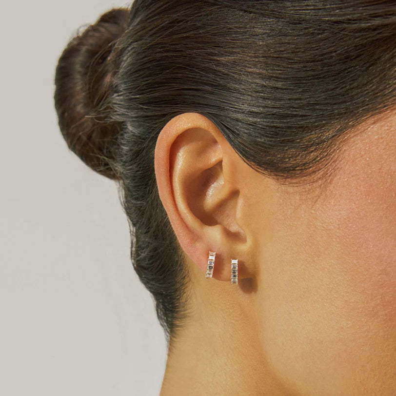 EF-Collection Prong Set Diamond Baguette Huggie Earrings in yellow gold styled on models ear