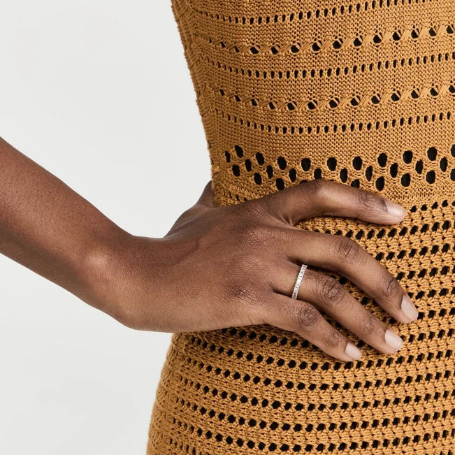 Single EF Collection Prong Set Diamond Baguette Ring in yellow gold on model’s hand