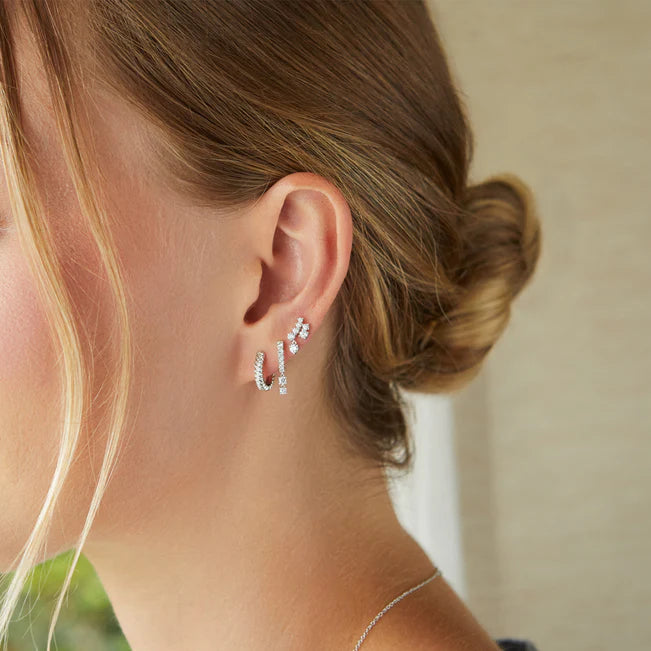 Close up of EF Collection Prong Set Diamond Double Drop Mini Huggie Earring in white gold styled on models ear.