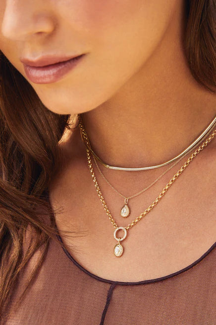 Close-up of a woman wearing multiple necklaces including the EF-Collection Rolo Chain Diamond Enhanced Necklace